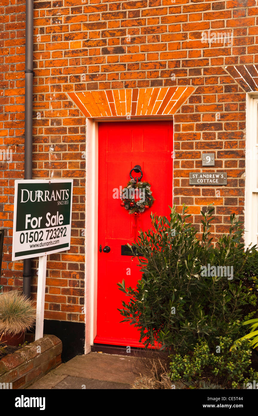 A pretty red brick cottage for sale at Southwold , Suffolk , England , Britain , Uk Stock Photo