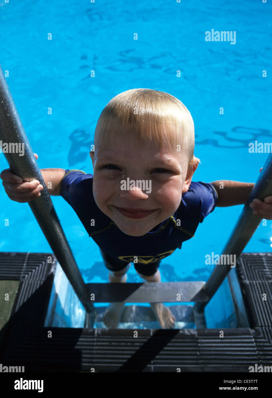 Young boy coming out of swimming pool Stock Photo Alamy