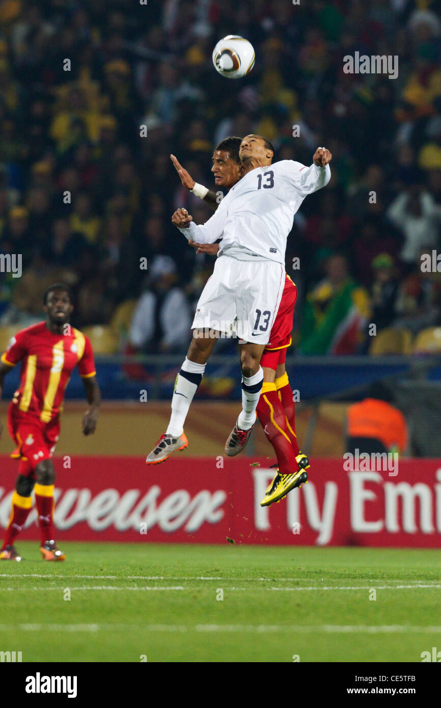 Ricardo Clark of the USA (13) and Kevin Prince Boateng of Ghana jump for a header during a 2010 FIFA World Cup round of 16 match Stock Photo