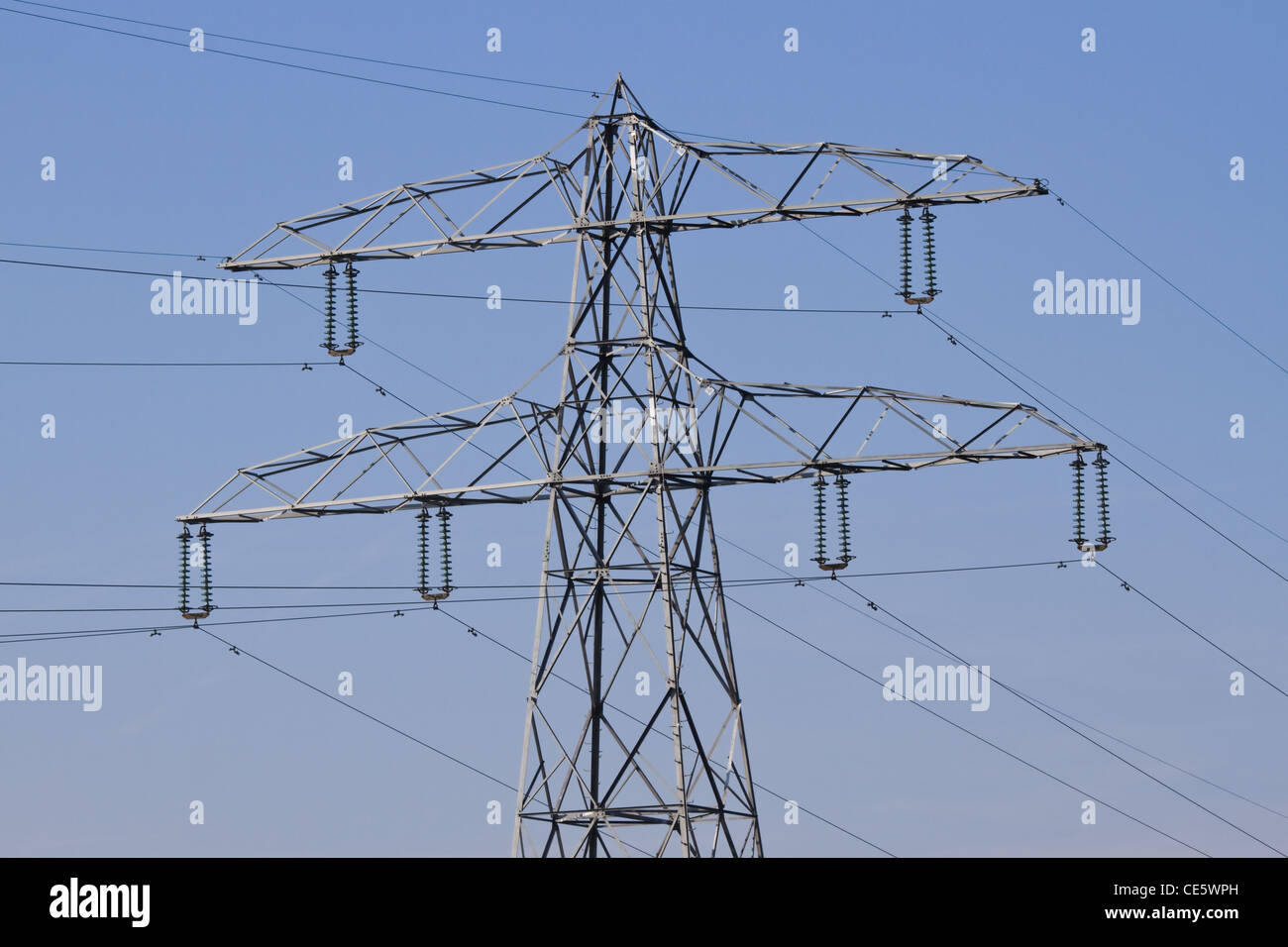 Pylon with electricity wires for energy supply and blue sky background Stock Photo