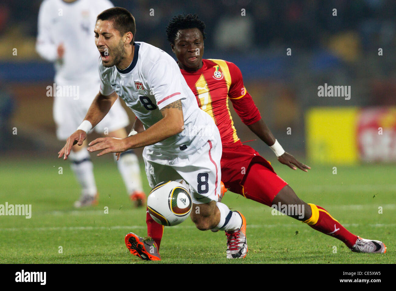 Samuel Inkoom of Ghana (R) tackles Clint Dempsey of the United States (L) during a 2010 FIFA World Cup round of 16 match. Stock Photo