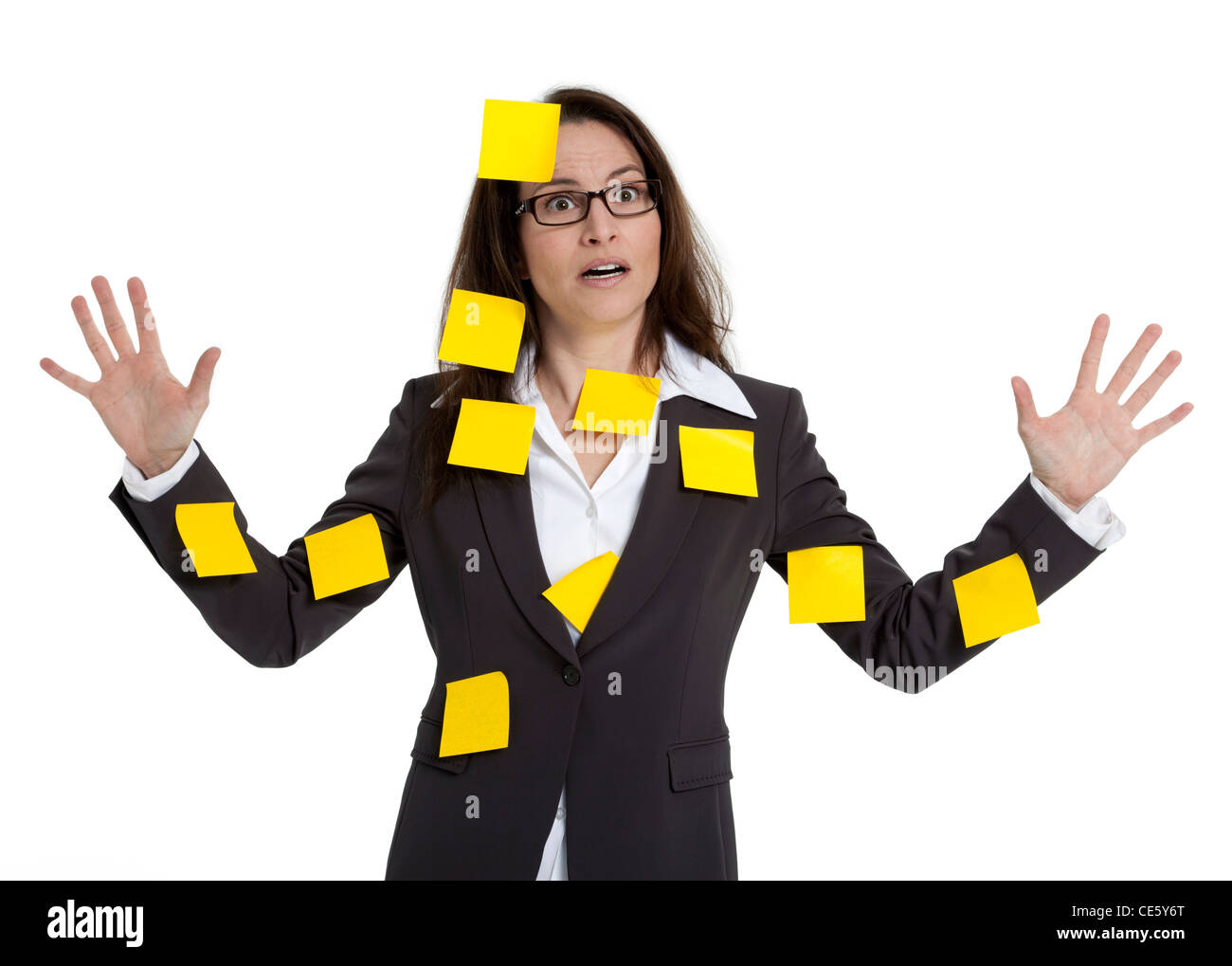 Stressed out business woman with numerous post-it notes stuck on her. White background. Stock Photo