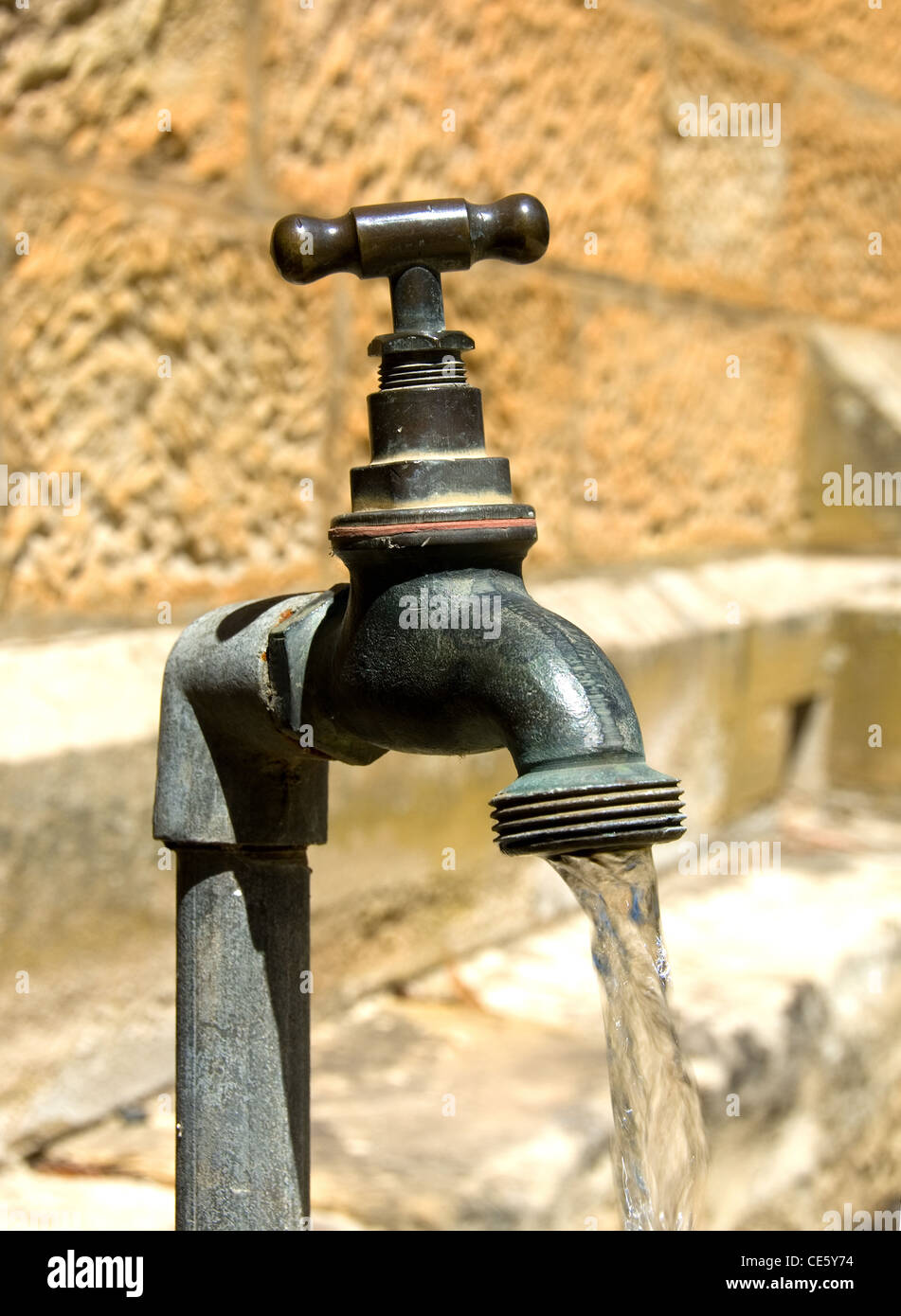 Water pouring from an old tap Stock Photo Alamy