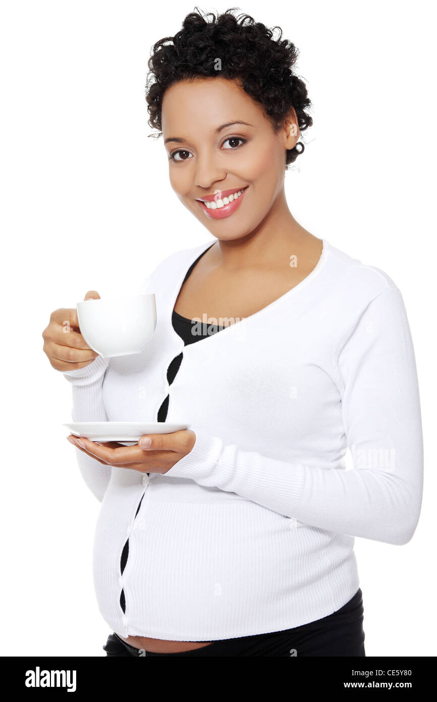 Front view portrait of a beautiful pregnant woman holding a cup of ...
