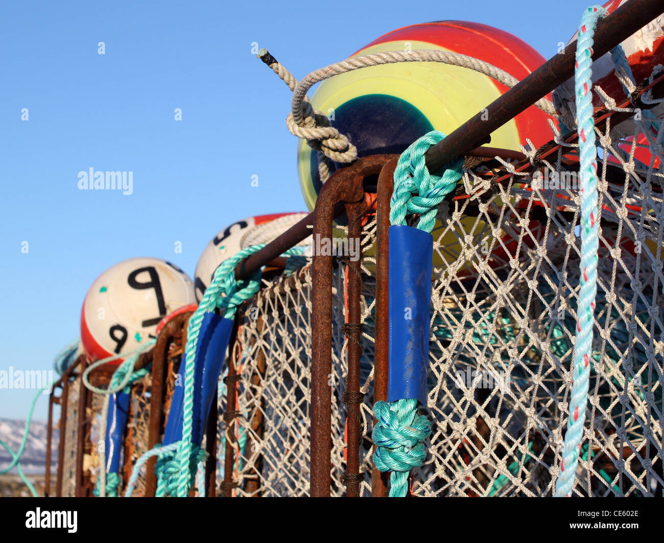Close up of large commercial crab pots and colorful floats with blue sky in  the background Stock Photo - Alamy