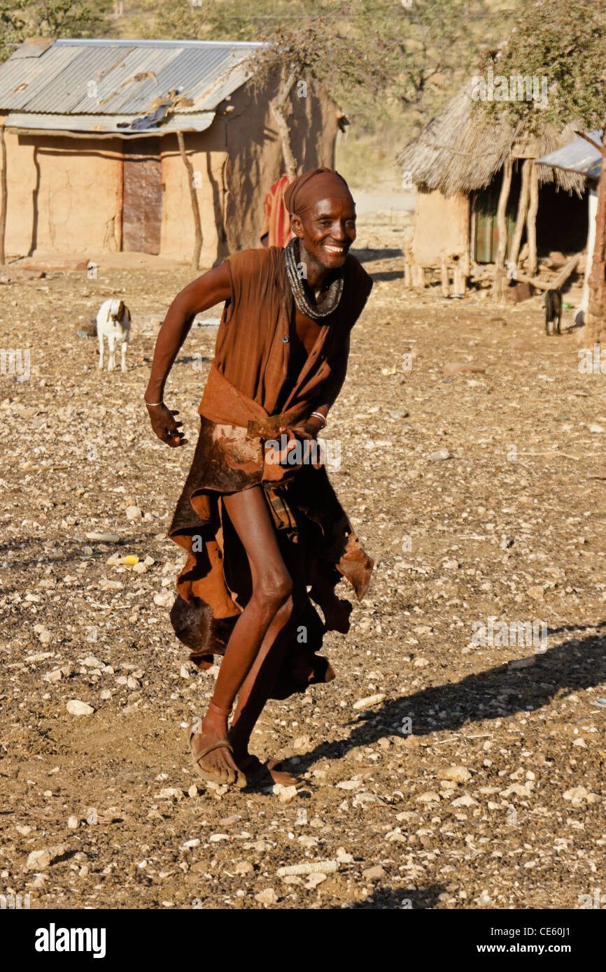 Himba man dancing in village near Opuwo, Namibia Stock Photo