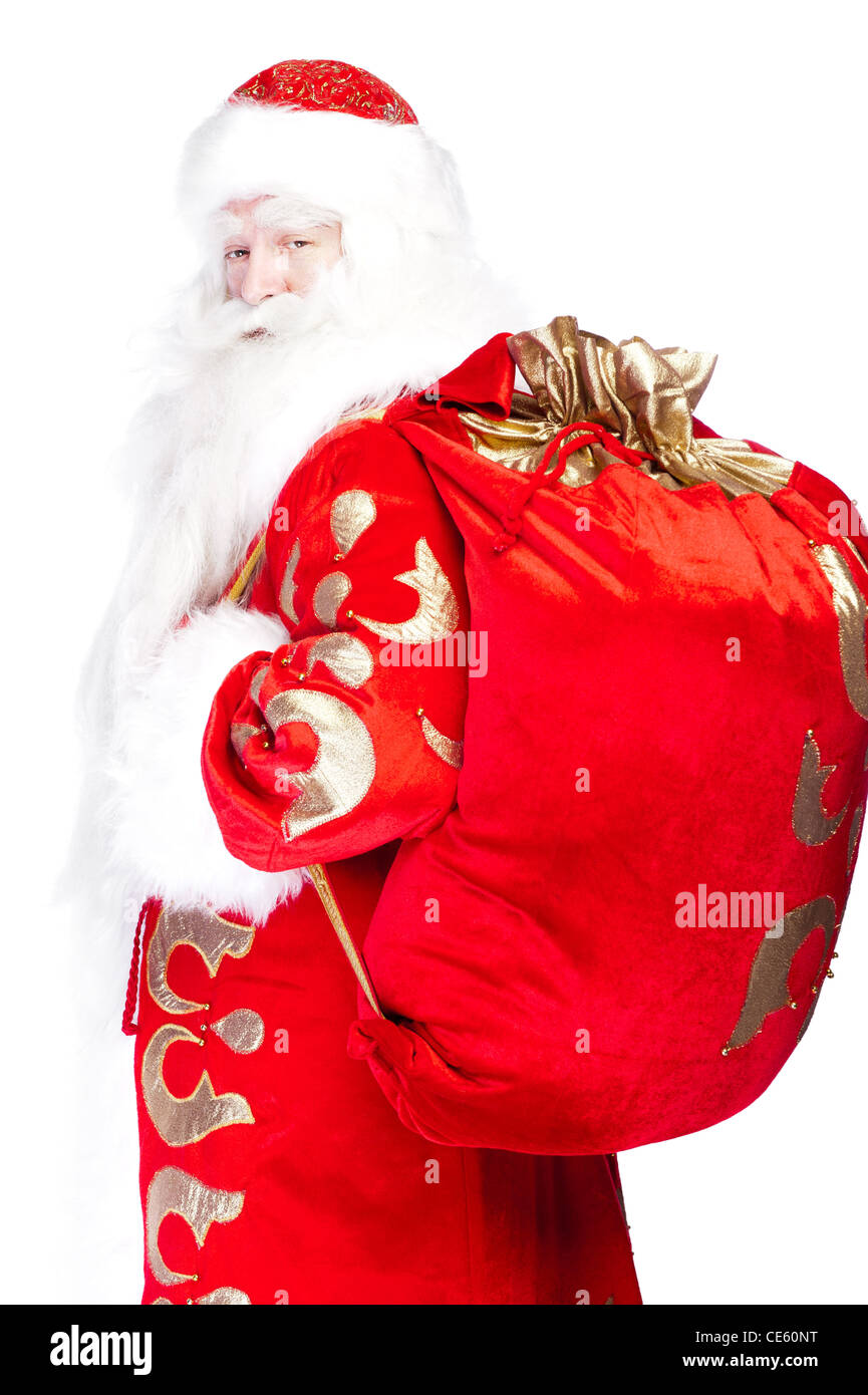 Santa Claus standing up on white background with his bag full of gifts ...