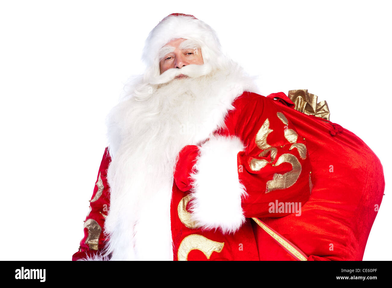 Santa Claus standing up on white background with his bag full of gifts ...