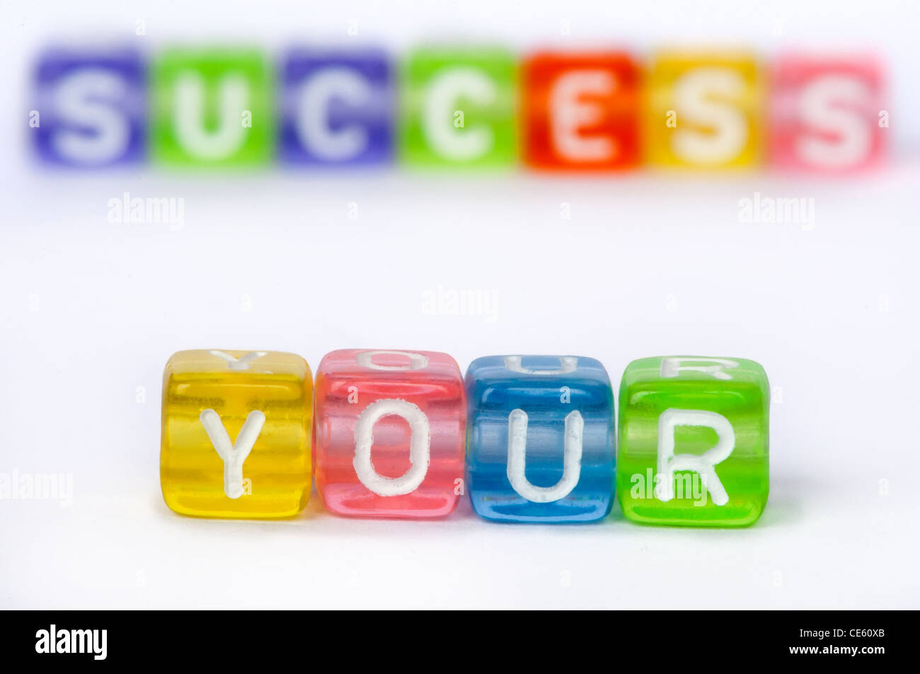 Text Your success on colorful wooden cubes over white Stock Photo - Alamy