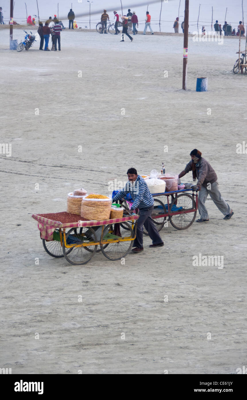 two hawkers selling fried Indian snacks at the banks of the river Ganga on the occasion of Magh Mela, Allahabad Stock Photo