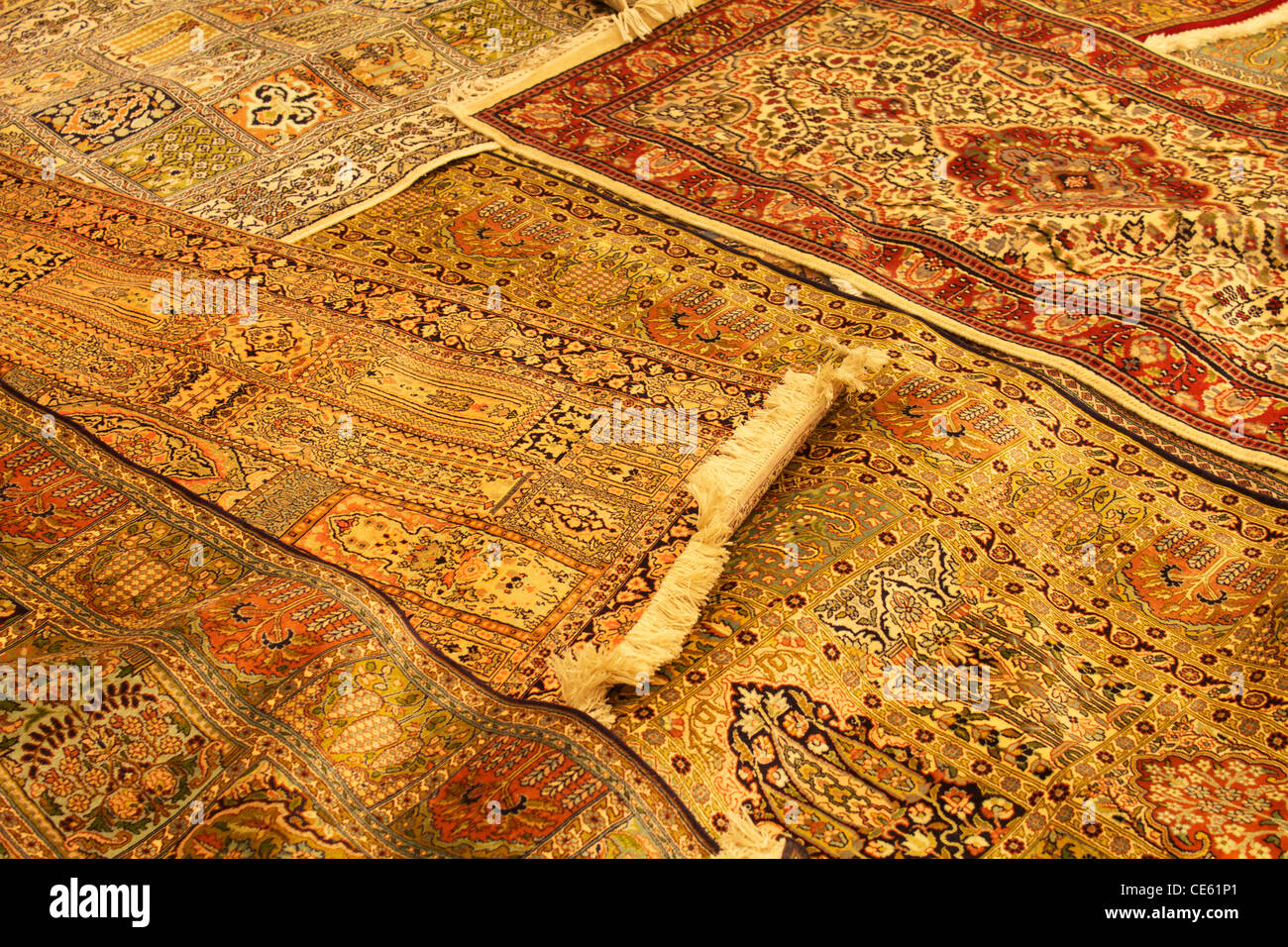 A selection of rugs for sale in a factory in Jaipur, India Stock Photo