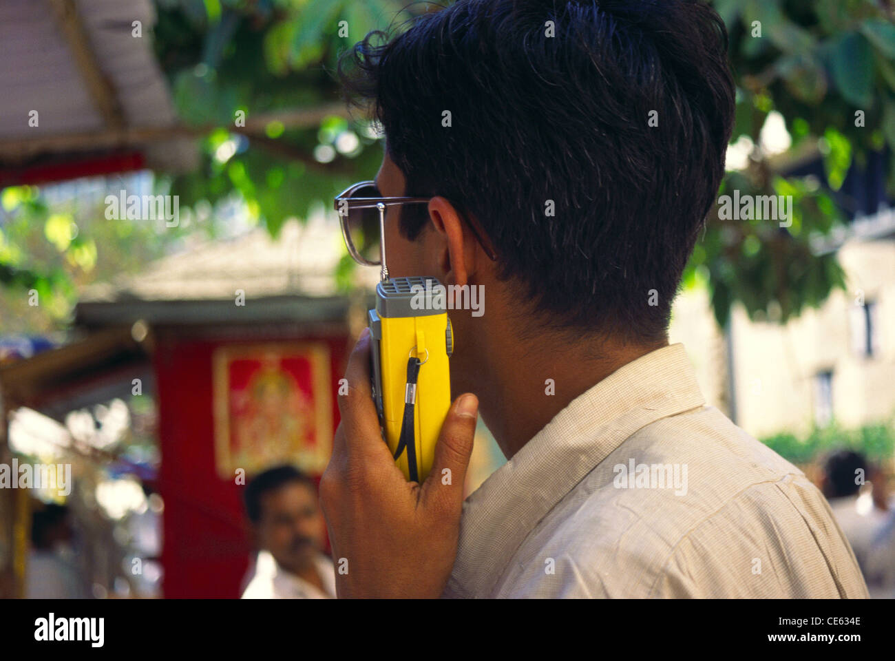 Man listening to cricket commentary on radio ; India Stock Photo