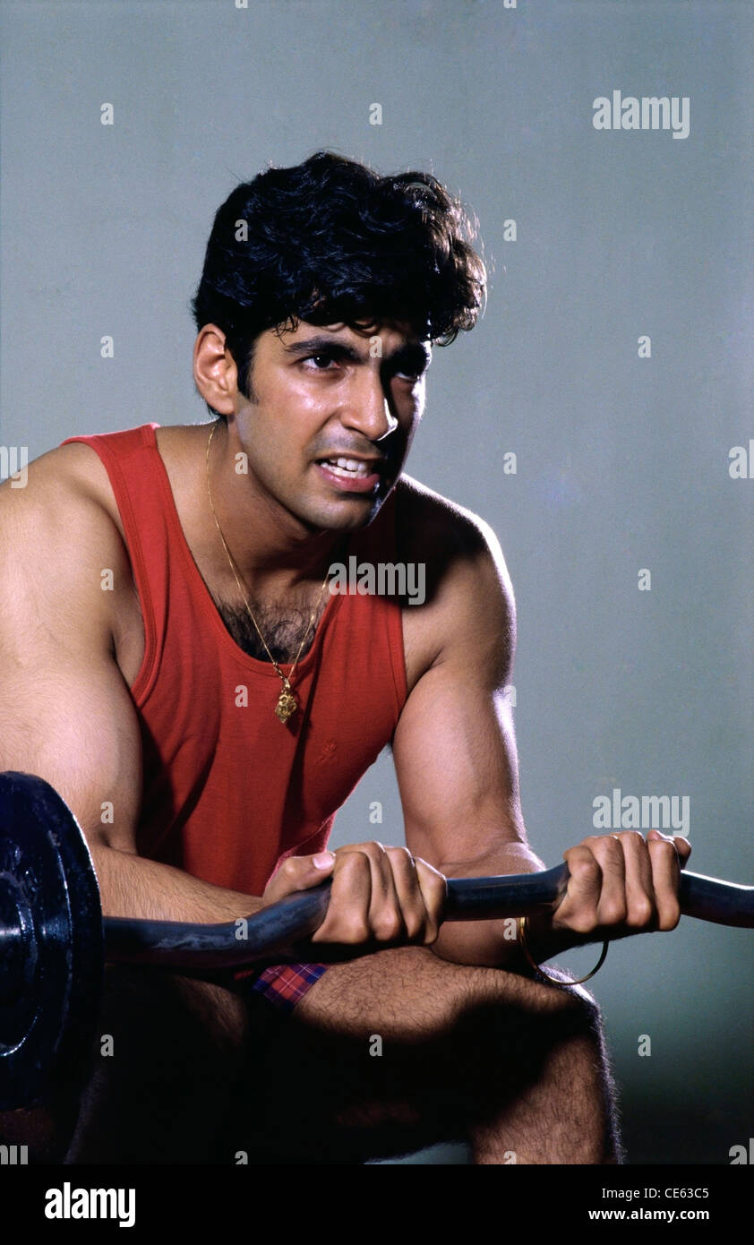 Indian man exercising lifting weights ; India ; asia ; MR#139 Stock Photo