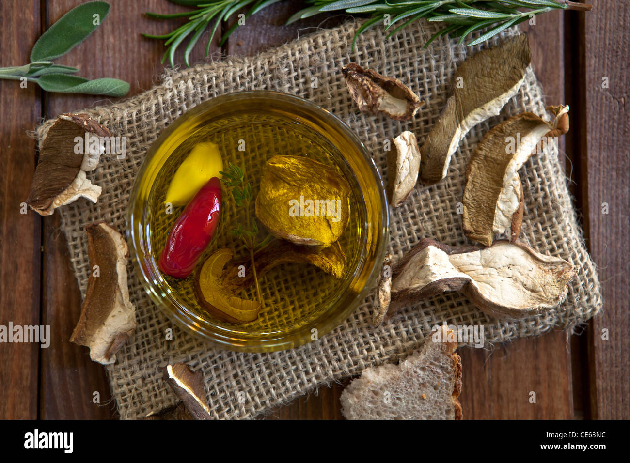 spicy mushroom oil with garlic, peppers and thyme Stock Photo