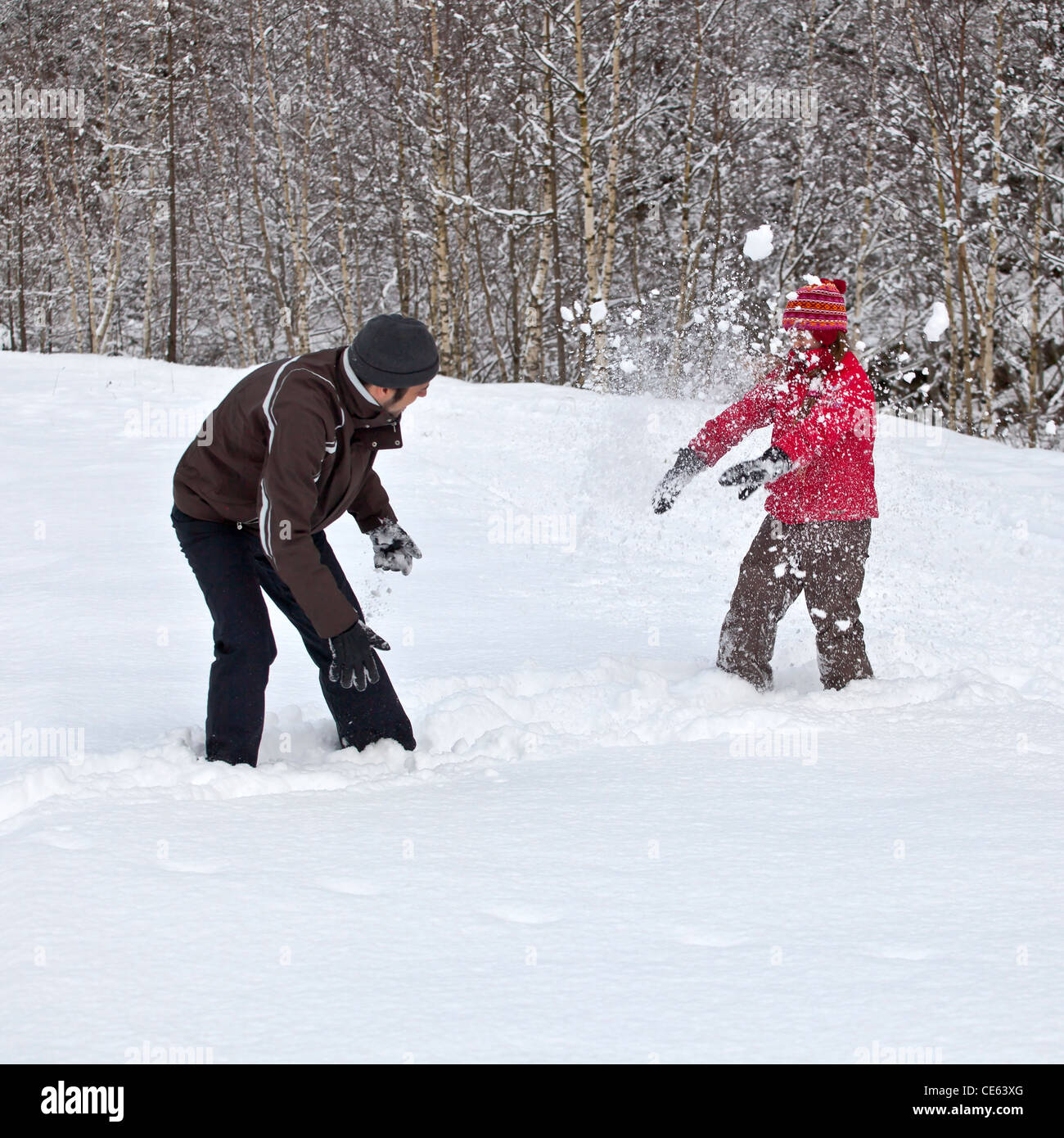 Father and daughter make a snowball fight in the snow Stock Photo