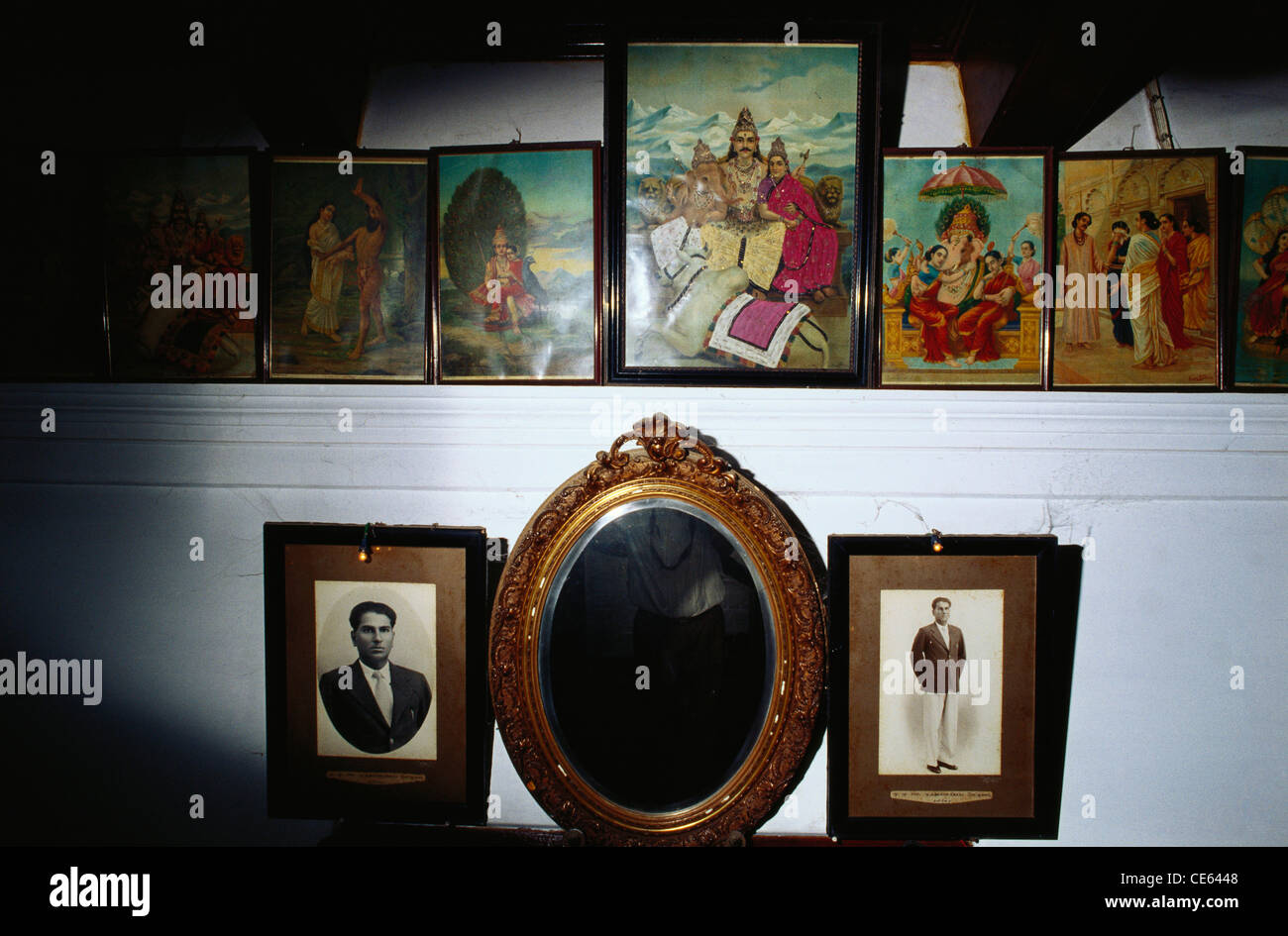 interior of Nattukottai Chettiar home with Raja Ravi Varma prints and mirror ; Chettinad ; Tamil Nadu ; India Stock Photo