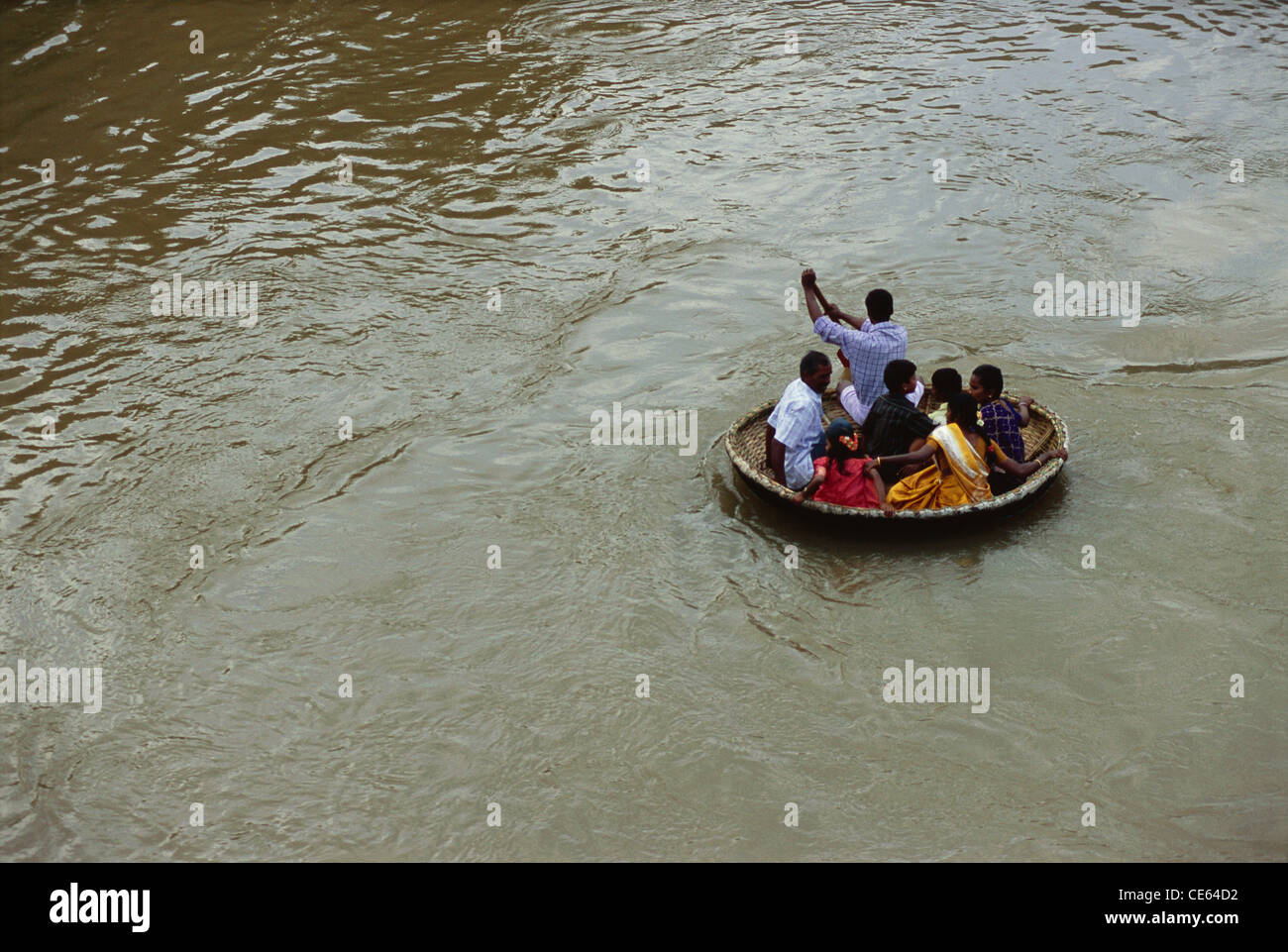 People in indian Coracle boat in Bhavani river Tamil Nadu India Stock