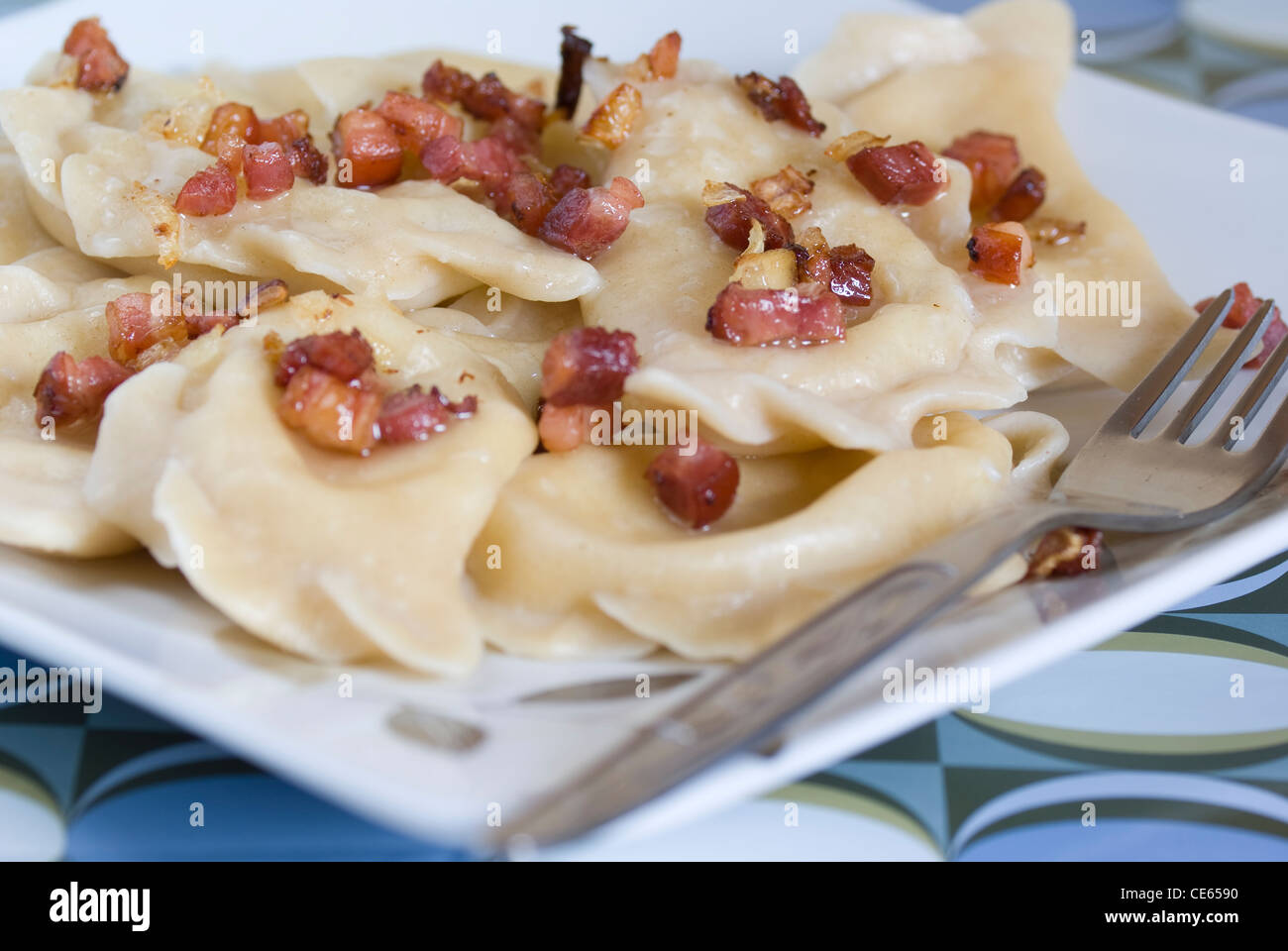 dumplings filled cheese and potatoes adorned bacon Stock Photo