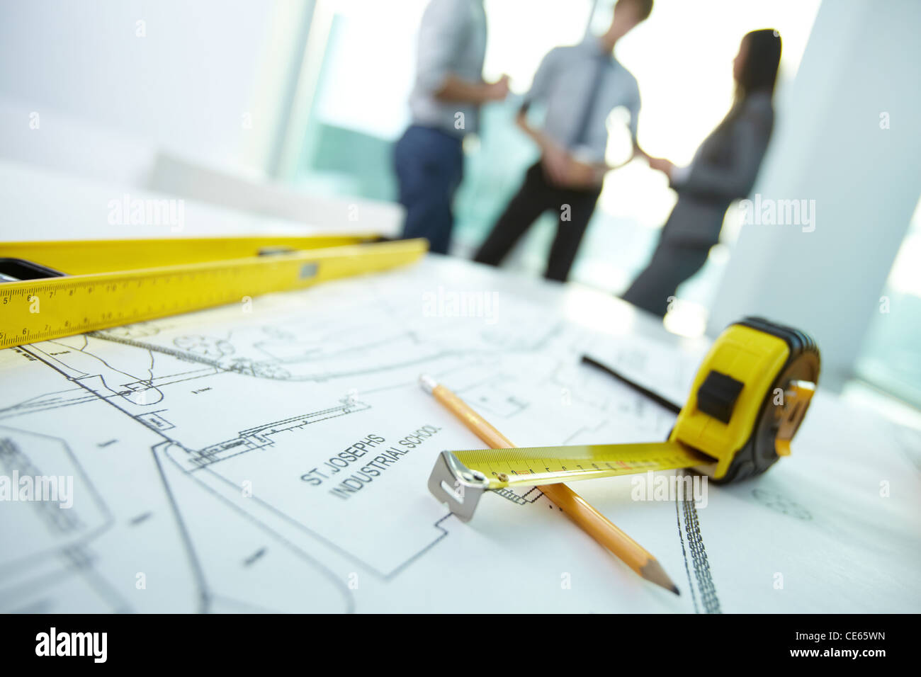 Image of engineering objects on workplace with three architects ...
