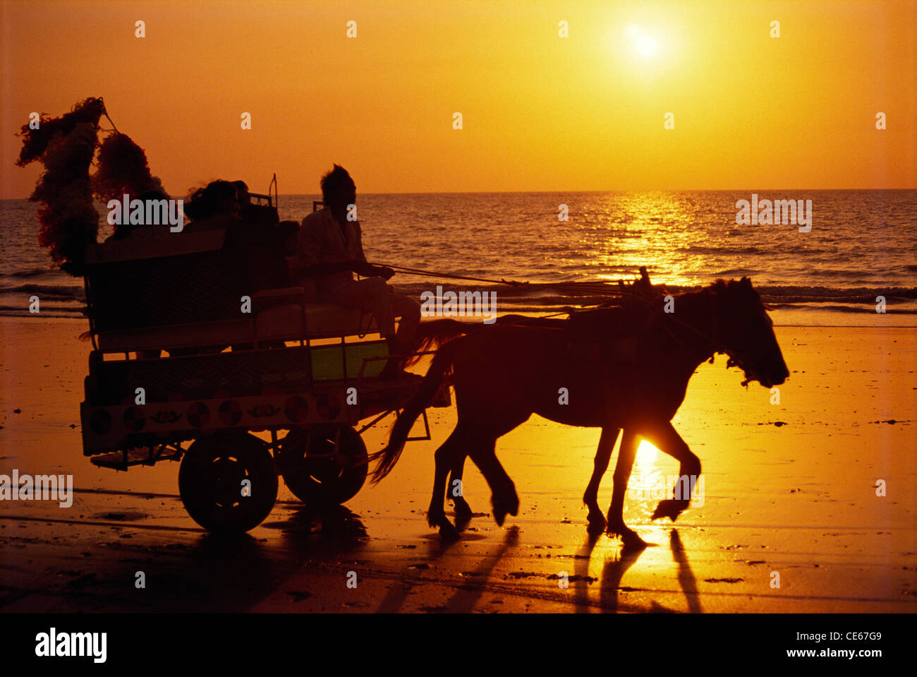 Horse cart ride at Juhu Beach in silhouette ; Bombay Mumbai