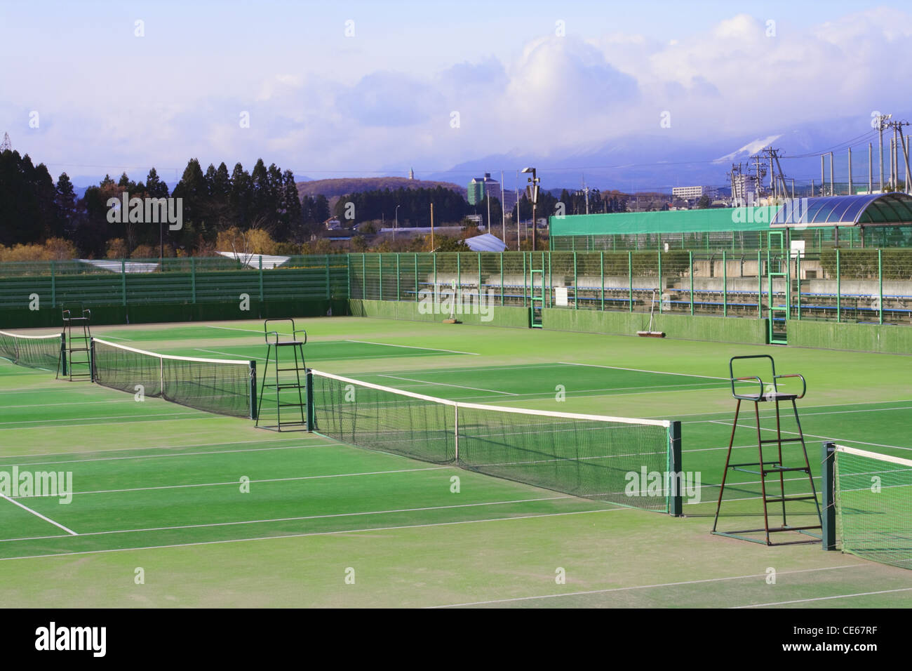 General view of few tennis courts in a sports complex at the margin of a city. Stock Photo