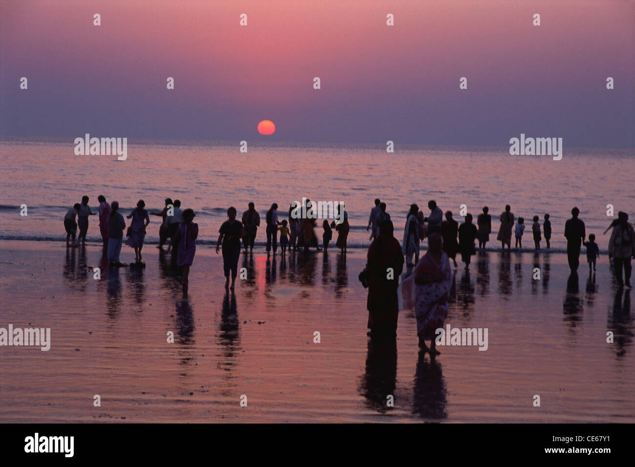 People at Juhu beach in silhouette ; Bombay Mumbai ; Maharashtra ; India Stock Photo