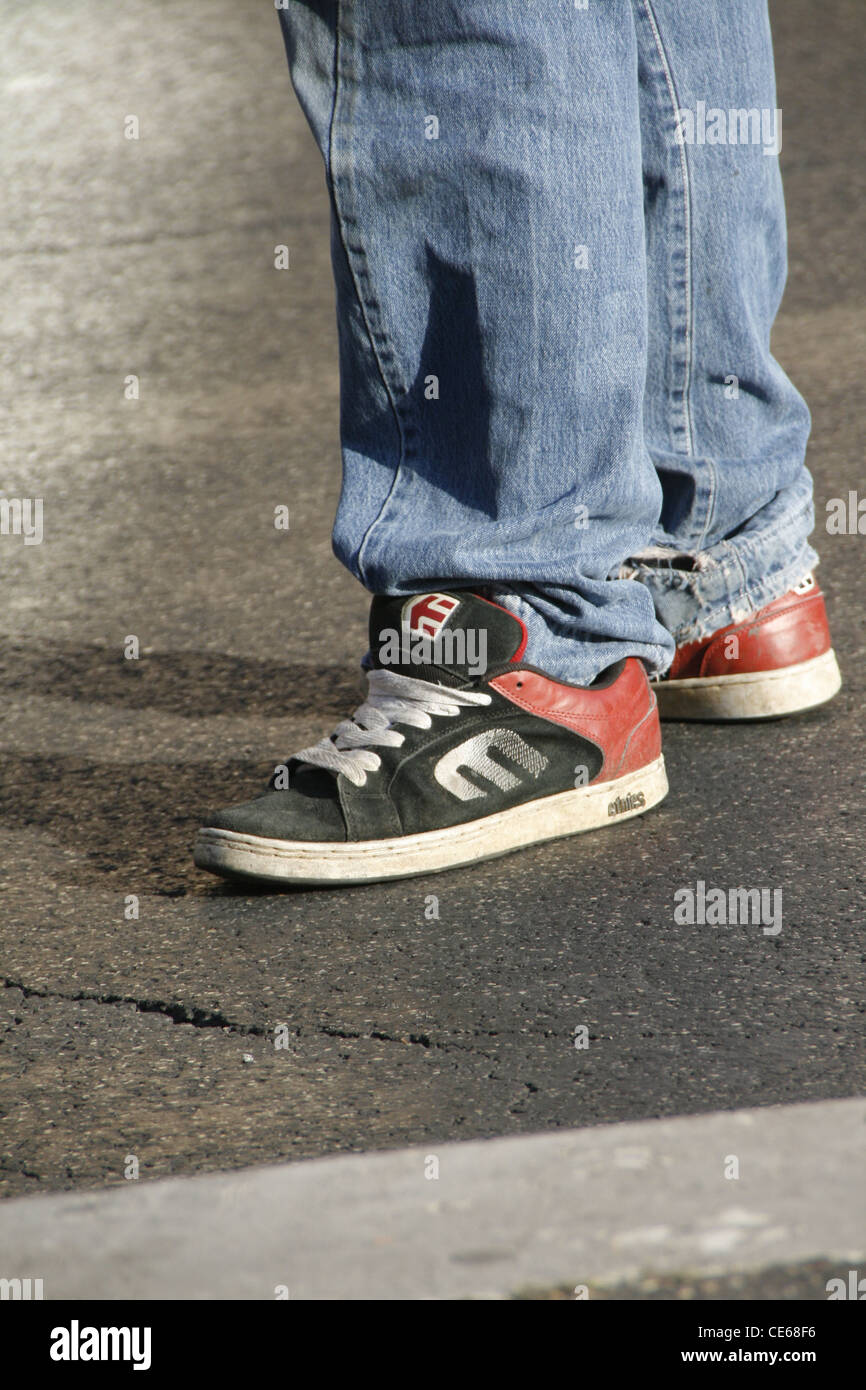 teenager wearing mitre sports shoes trainers in street road in city town  Stock Photo - Alamy