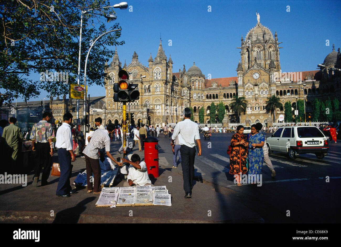 Newspaper vendor ; Victoria Terminus ; VT ; Chhatrapati Shivaji Terminus ; CST ; railway station ; Bombay ; Mumbai ; Maharashtra ; India ; Asia Stock Photo