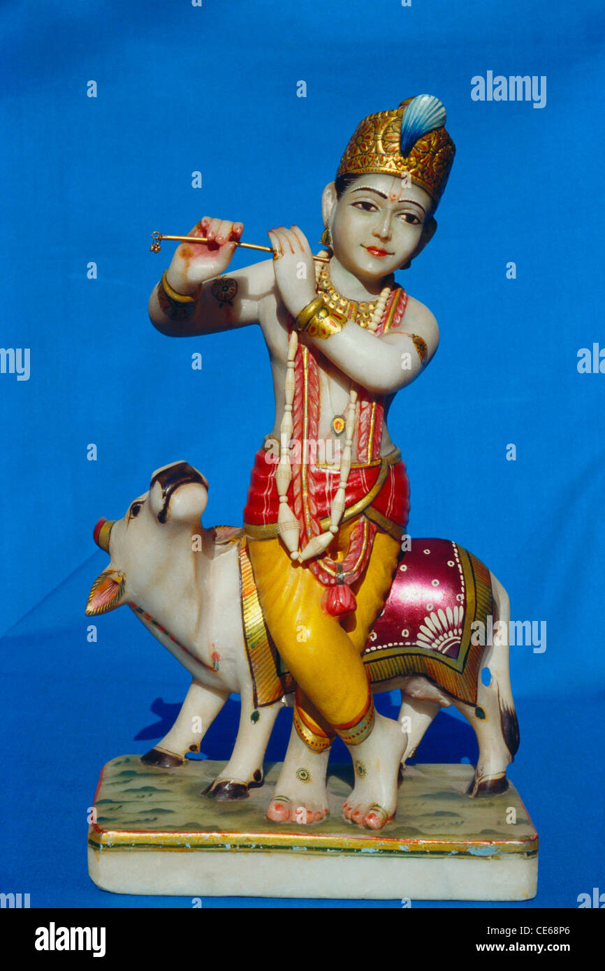 Lord Bal Krishna playing flute with cow ; marble idol ; Jaipur ; Rajasthan ; India ; Asia Stock Photo