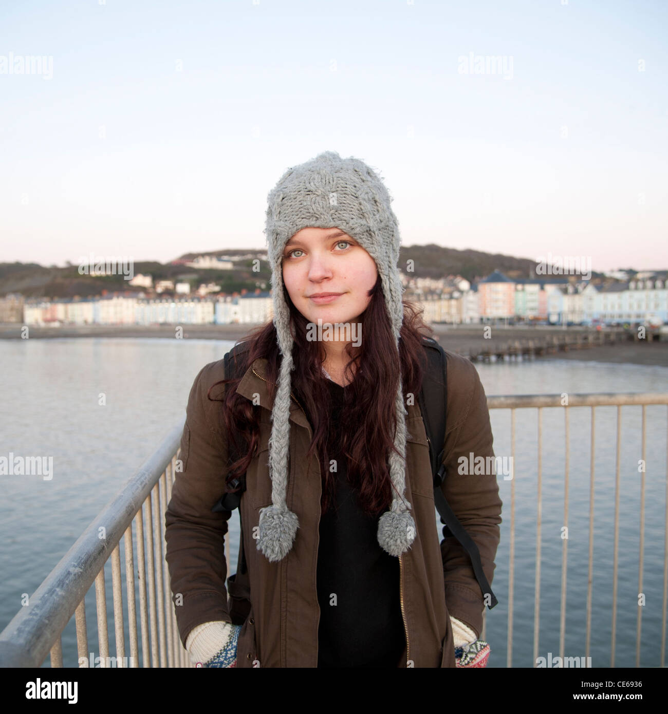 A pretty young woman 16 17 18 year old teenage girl wearing hat cap, alone, outdoors, UK Stock Photo