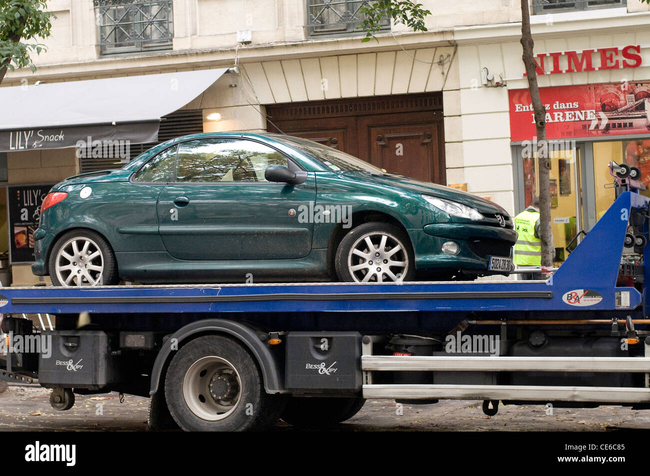Parked car being removed by Traffic Police in Nimes,France,Europe Stock Photo