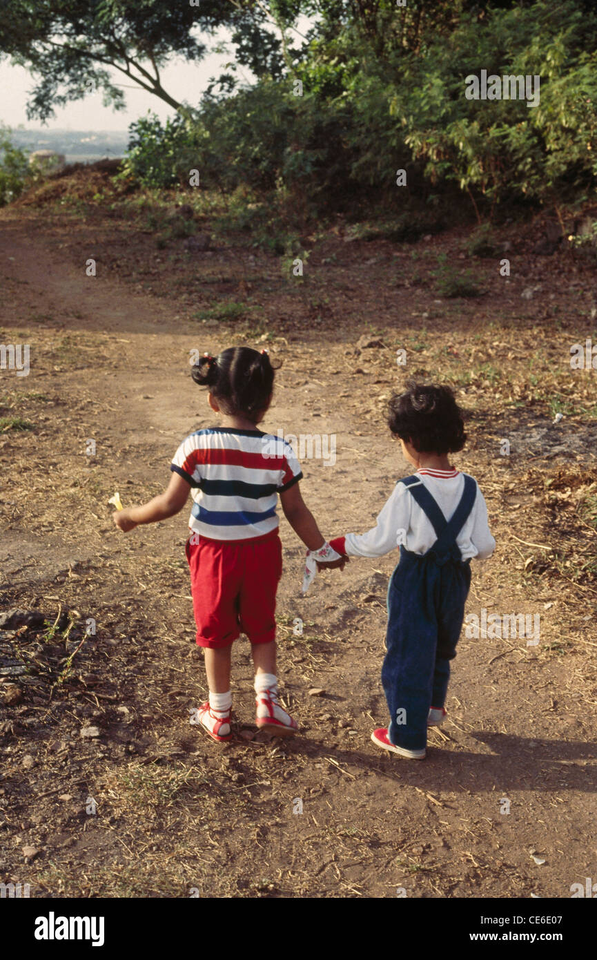 brother and sister walking holding hands in park Stock Photo - Alamy
