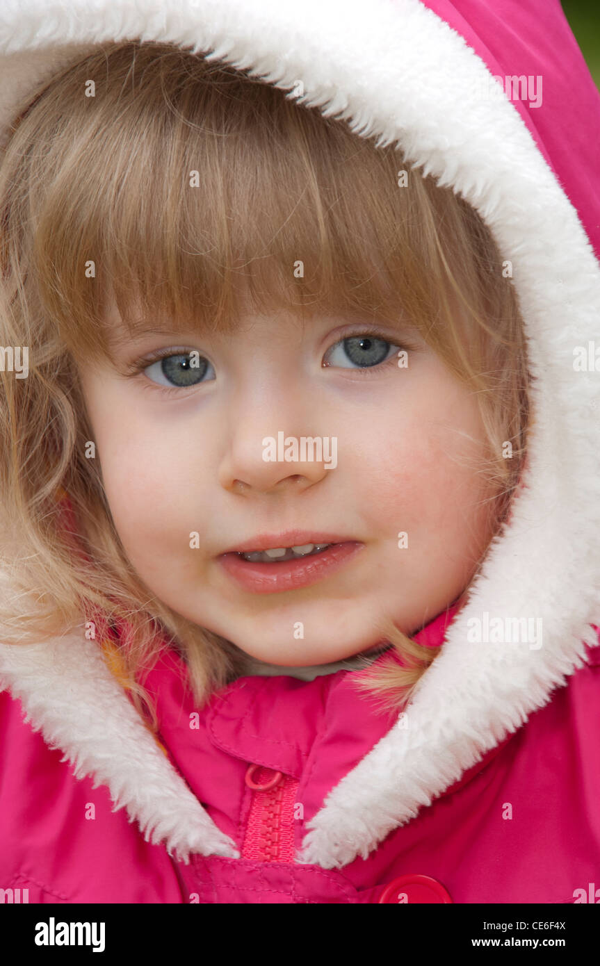young girl wearing pink coat Stock Photo Alamy