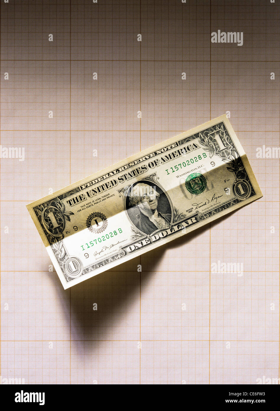 UNFOLDED 1 US DOLLAR BANKNOTE ON GRAPH PAPER Stock Photo