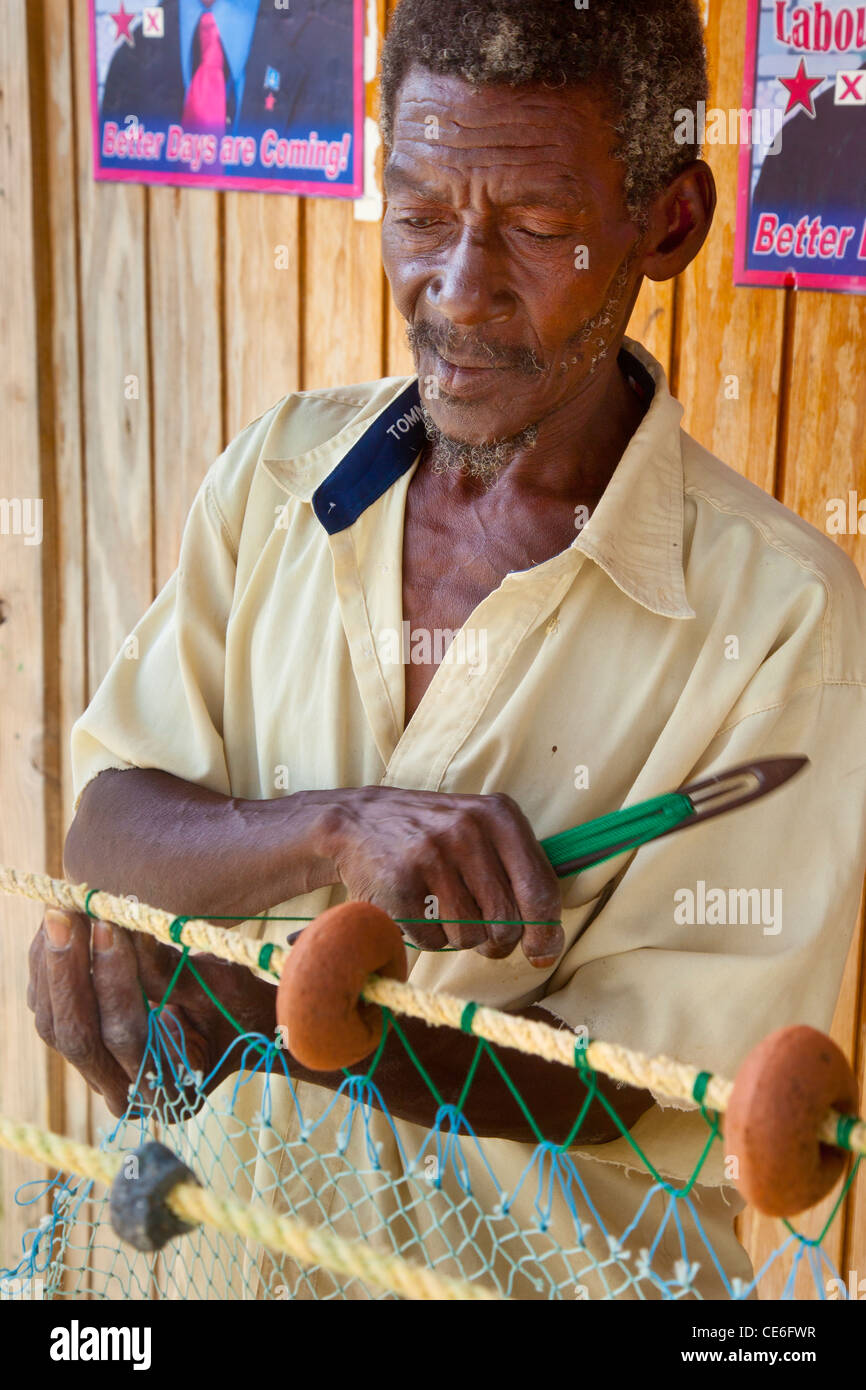 Fisherman mending his nets in Canaries, St. Lucia, West Indies Stock Photo
