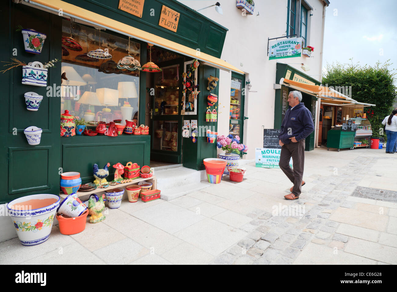 People strolling amongst the shops and restaurants in the Ville Close, the historic quarter of Cocarneau, Brittany, France. Stock Photo