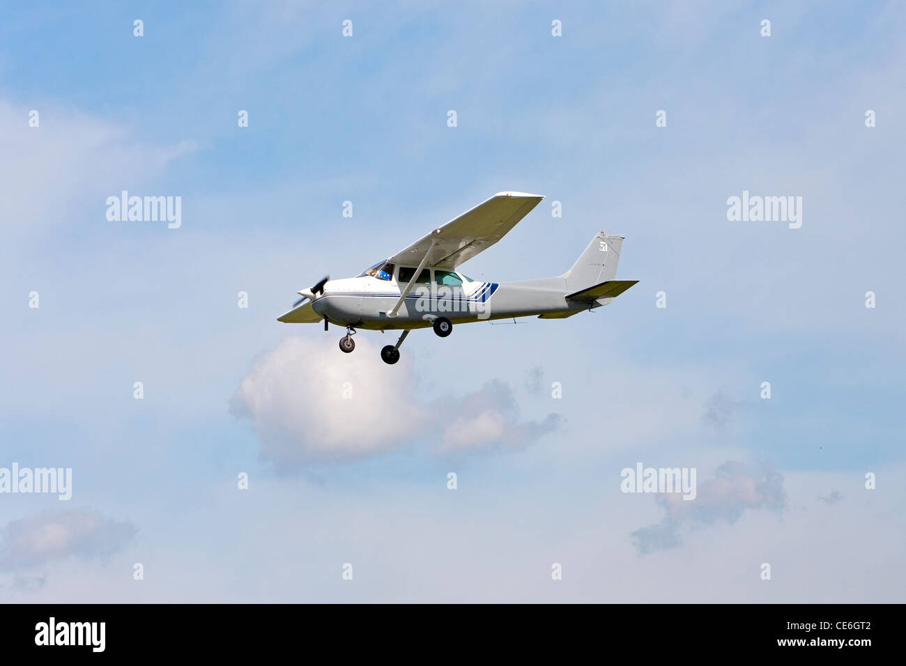 A Cessna plane in flight in the sky. Stock Photo