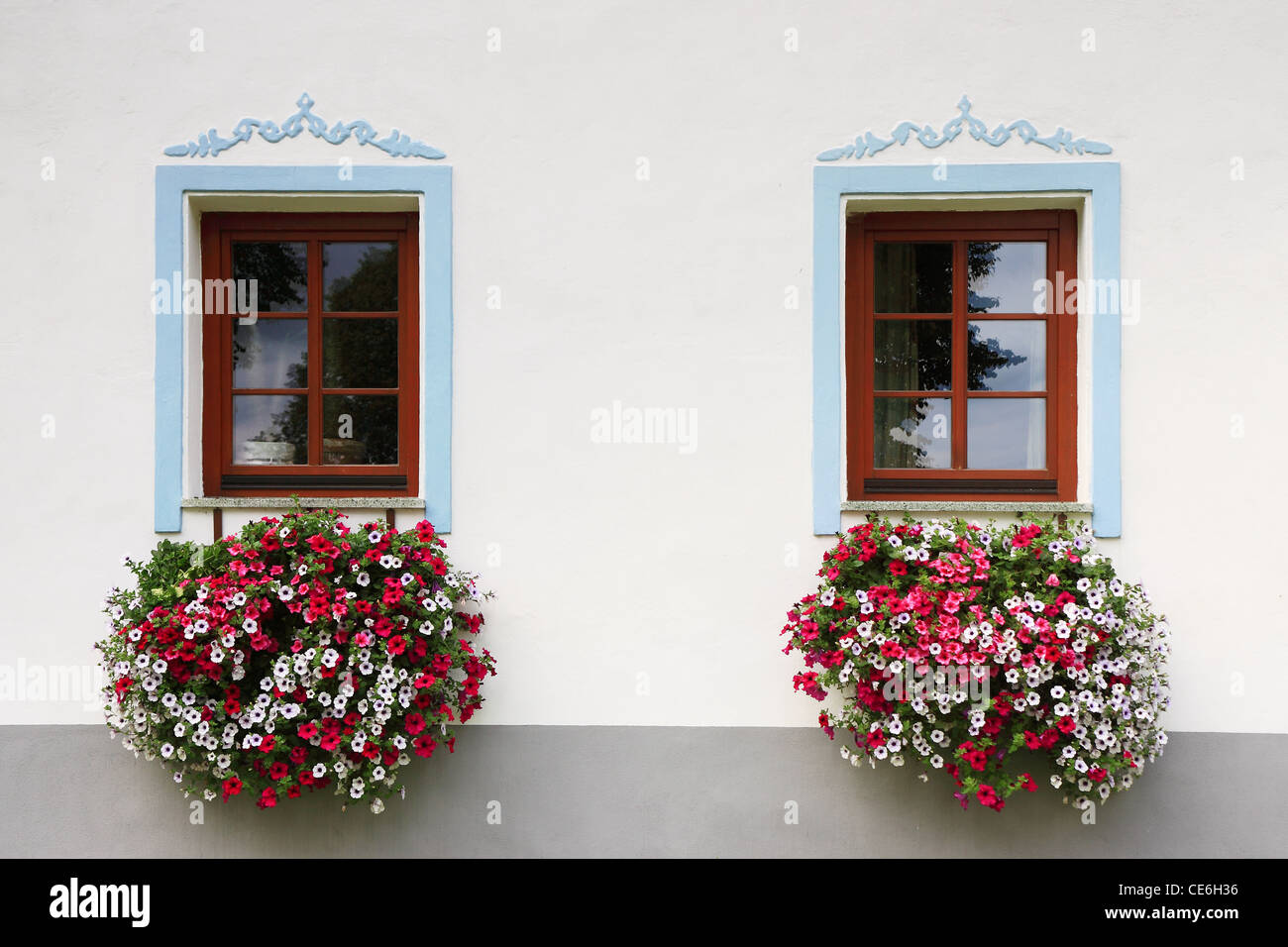 close-up two wood old windows with flowers Stock Photo - Alamy
