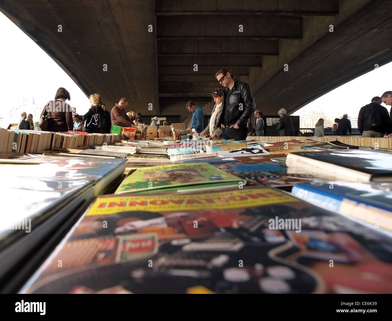 People browse the second hand books at the Waterloo Bridge Book Market Stock Photo
