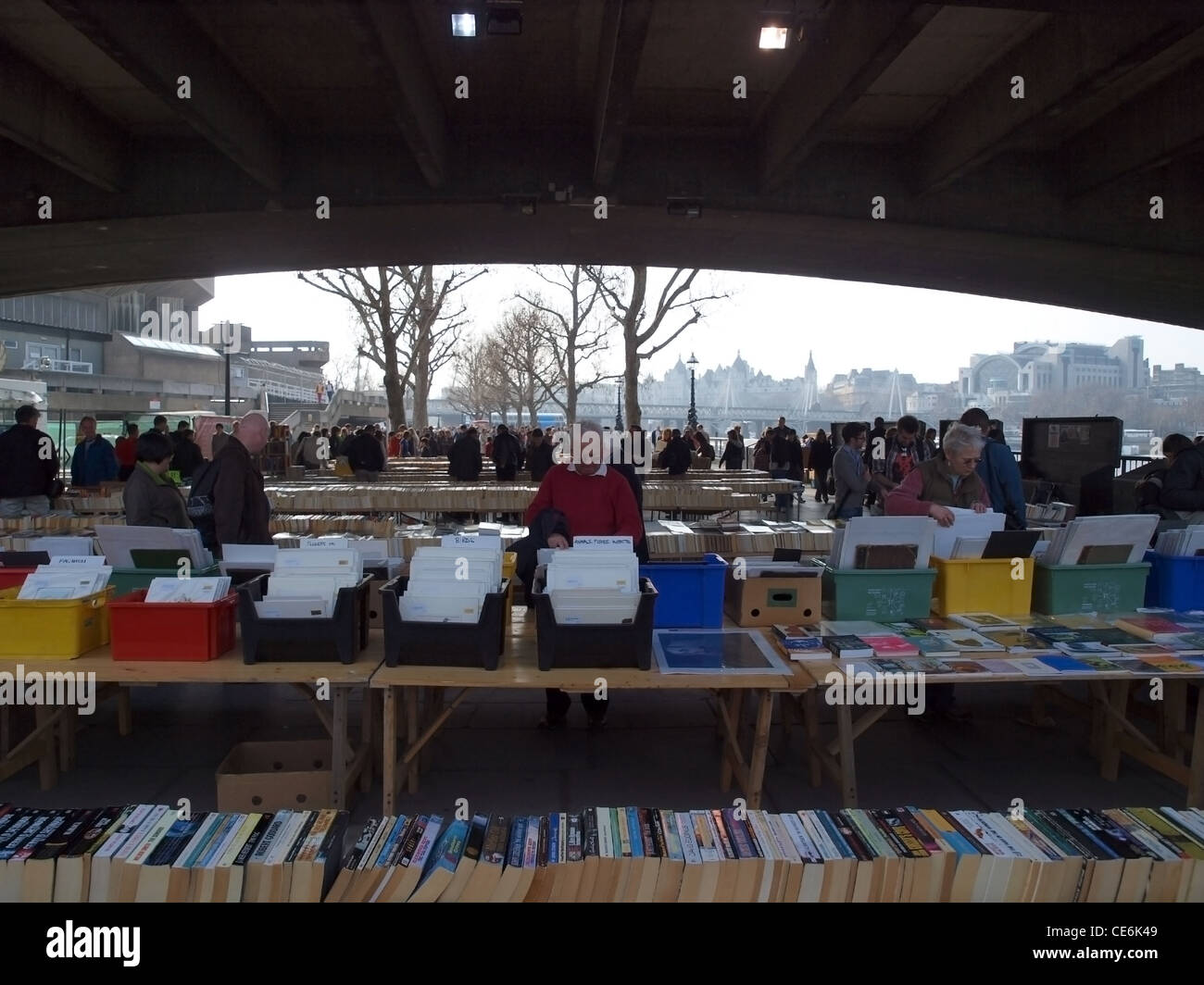 People browse the second hand books at the Waterloo Bridge Book Market Stock Photo