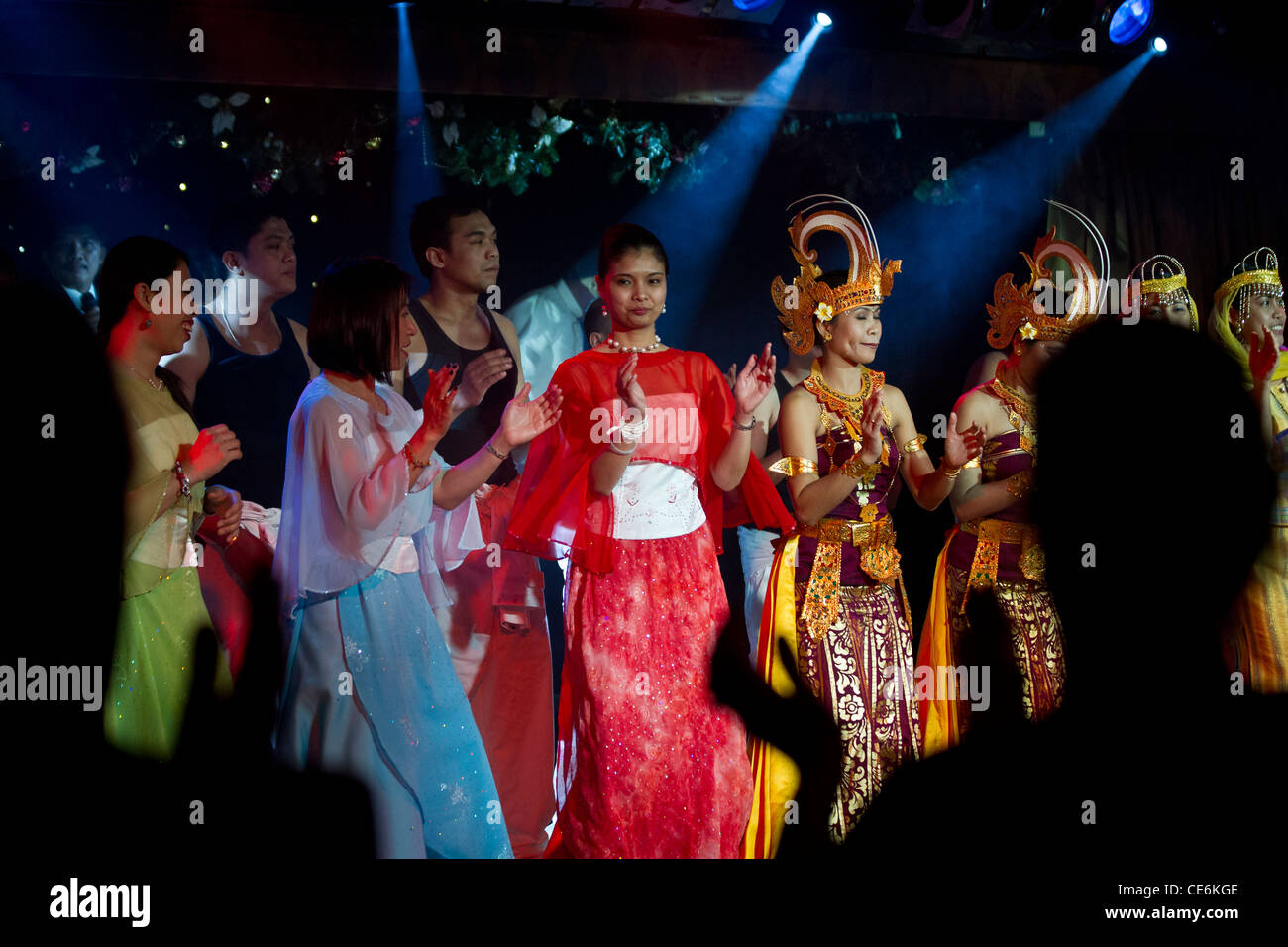 Crew members of cruise ship Boudicca putting on a show to entertain passengers: traditional dancing and costumes. Stock Photo