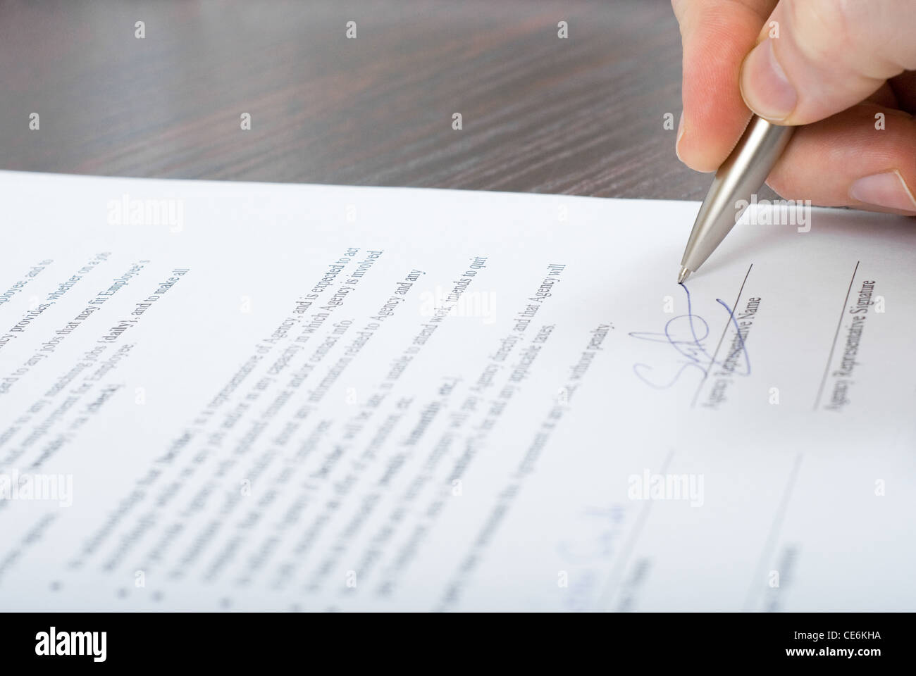 Close up shoot of signing contract by a businessmen with silver pen ...