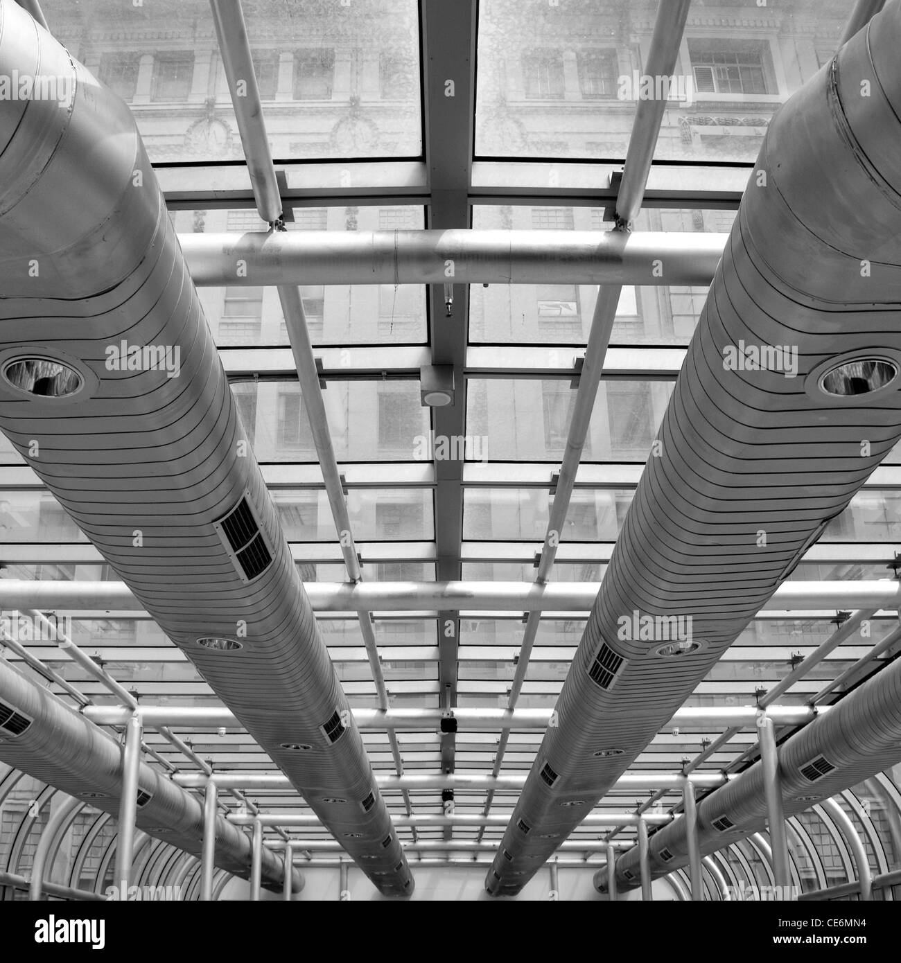 Air conditioning ducts in an abovestreet covered walkway, linking two