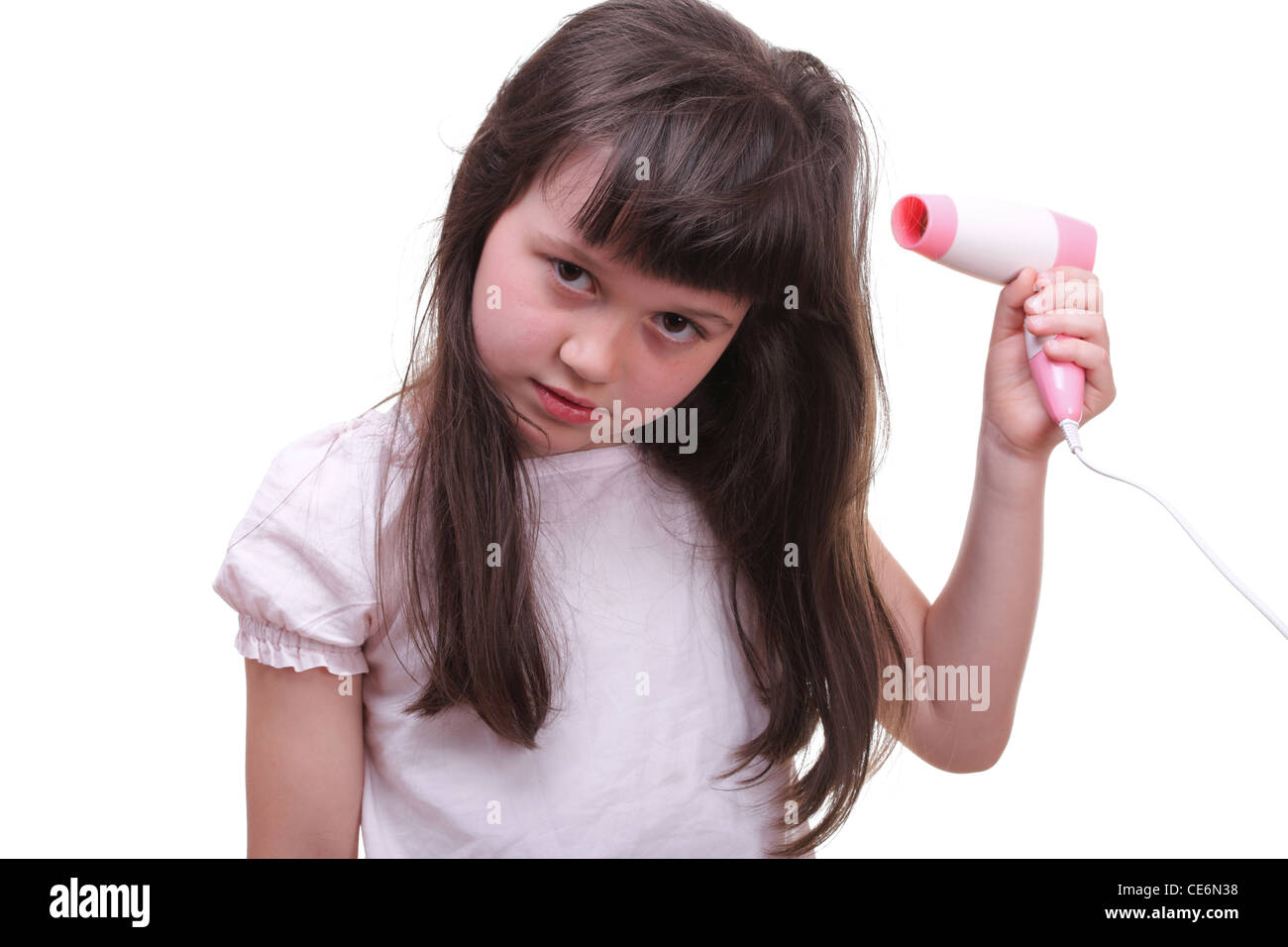 Pretty girl drying her hair hairdryer isolated on white Stock Photo - Alamy