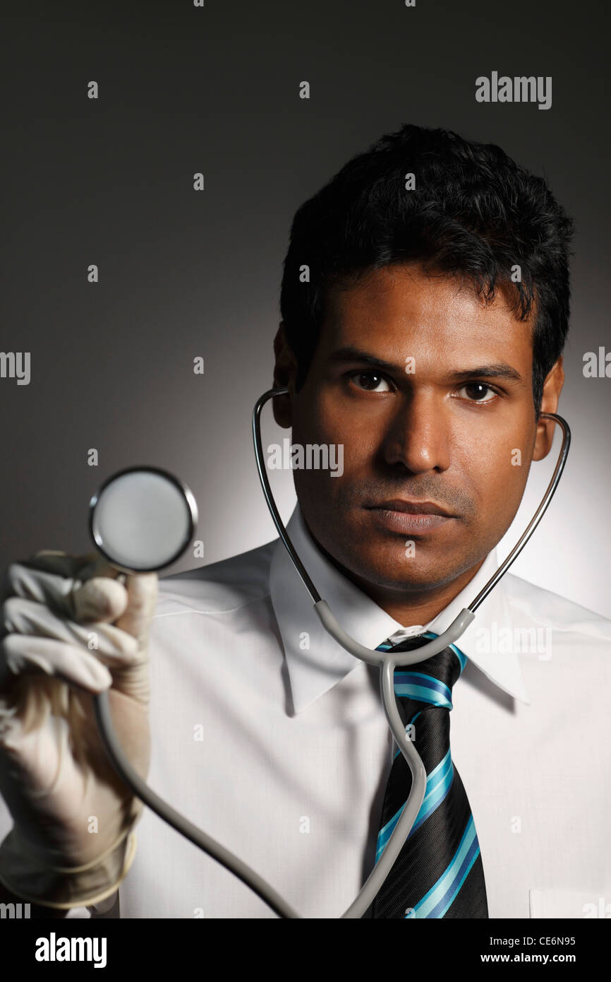 head shot of doctor holding stethoscope Stock Photo Alamy