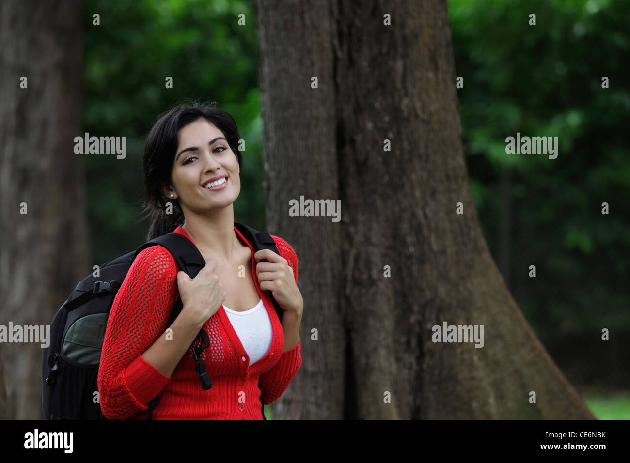 Mid shot of young woman wearing back pack and smiling Stock Photo