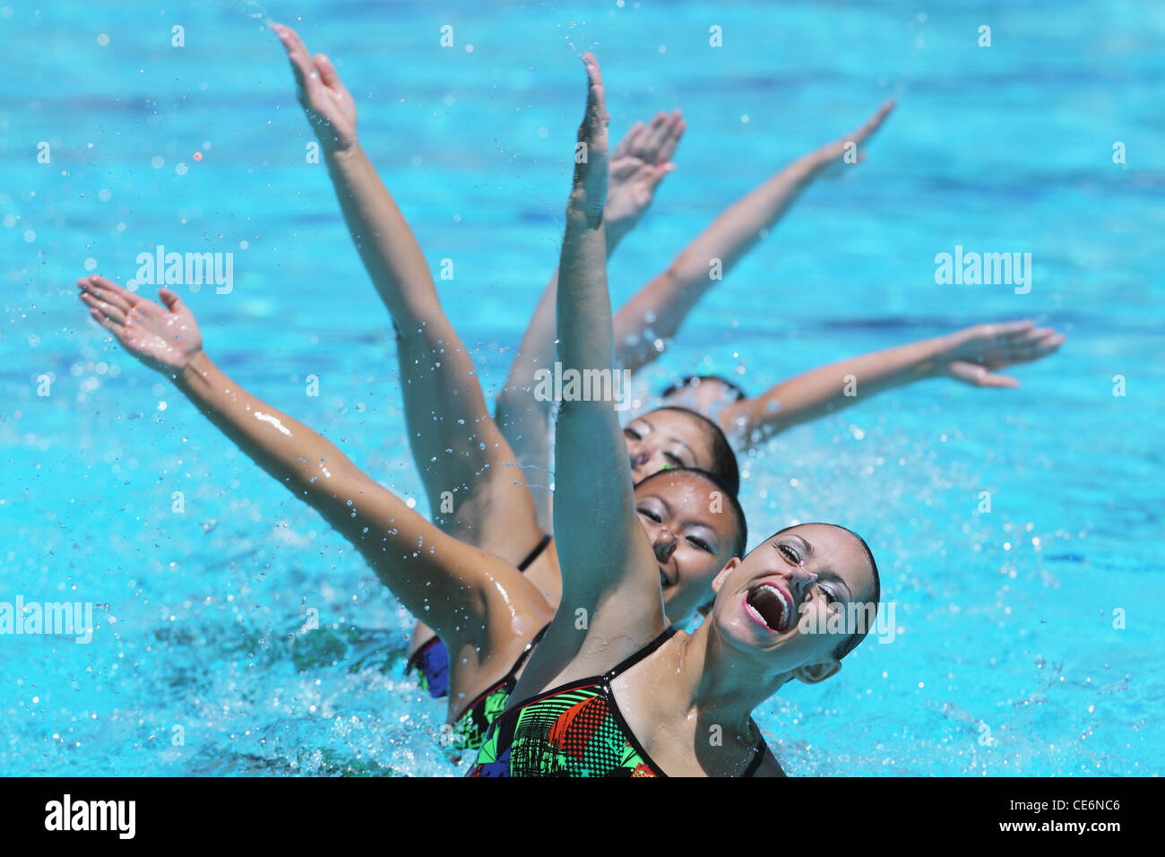 Group of Synchronized Swimmers Performing in Swimming Pool Stock Photo