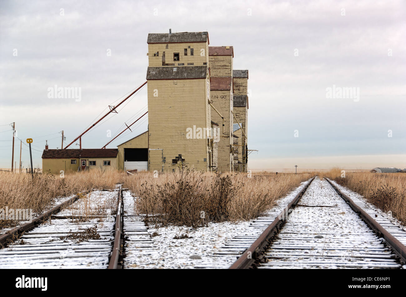 A winter scene of three old abandoned grain elevators located at Mossleigh, Alberta, Canada. Stock Photo