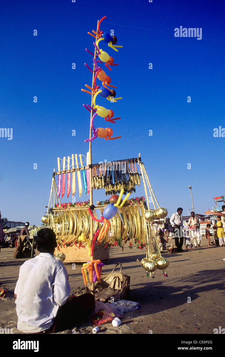 Indian hawker selling balloons toys on Juhu beach ; bombay ; mumbai