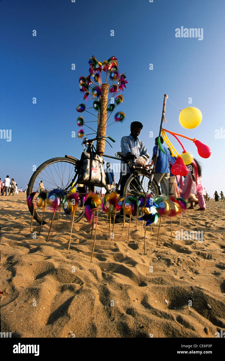 Paper windmill and balloon seller ; Marina beach ; Chennai ; India Stock Photo